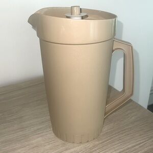 64 oz  Vintage Tupperware beige and white pitcher. Looks new. Tight lid.